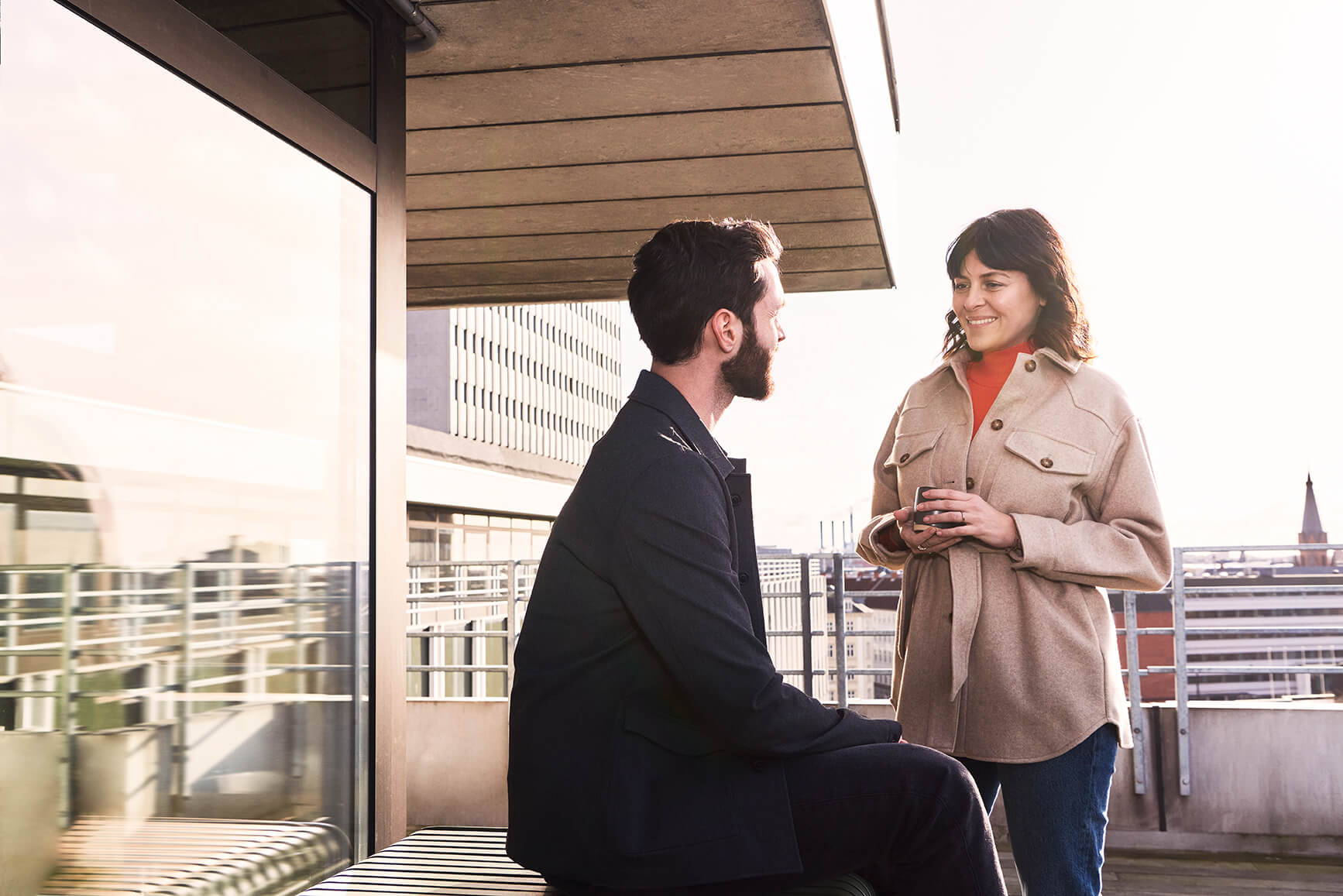 Conversation between two people on a rooftop