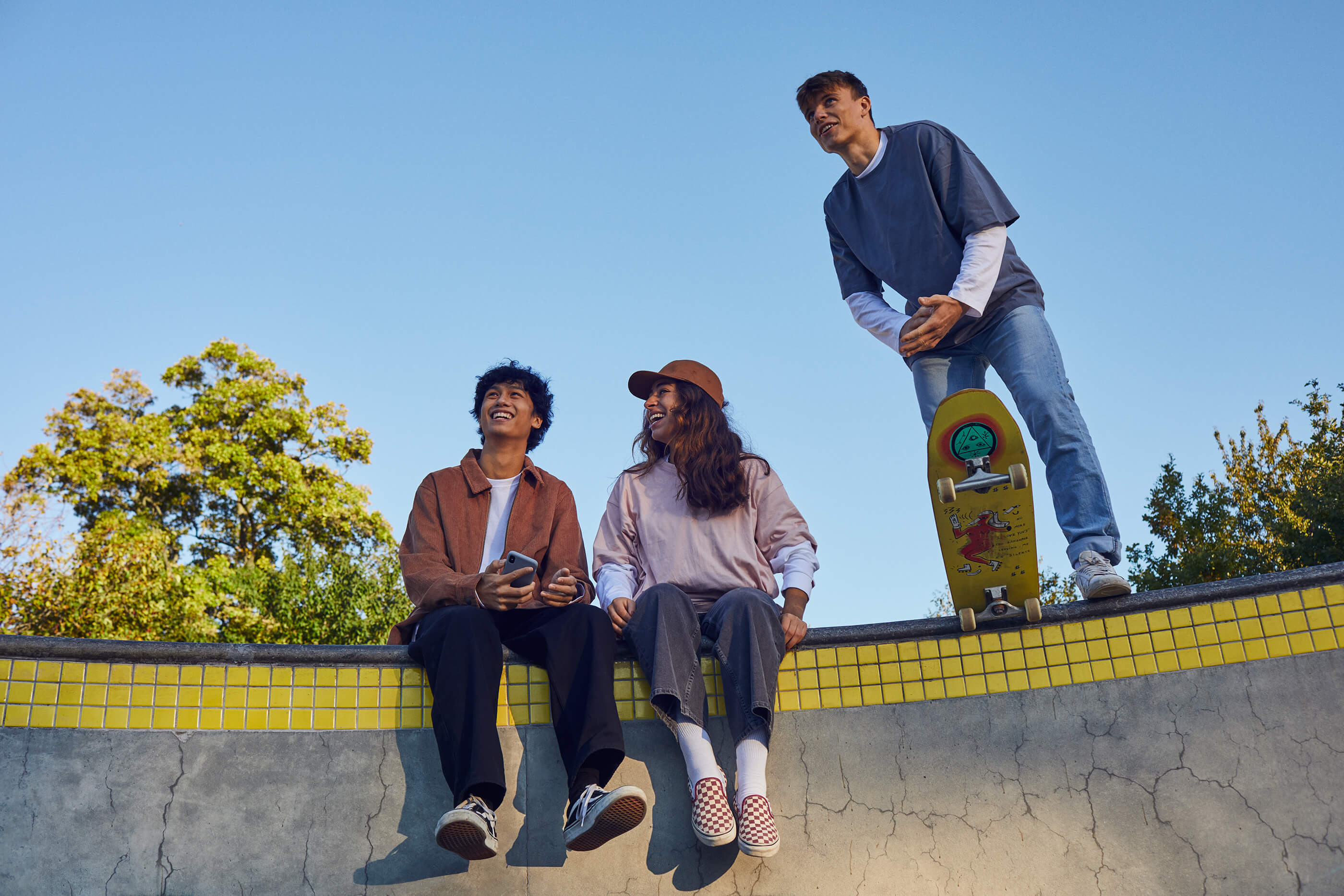 Friends hanging out in a scate park.